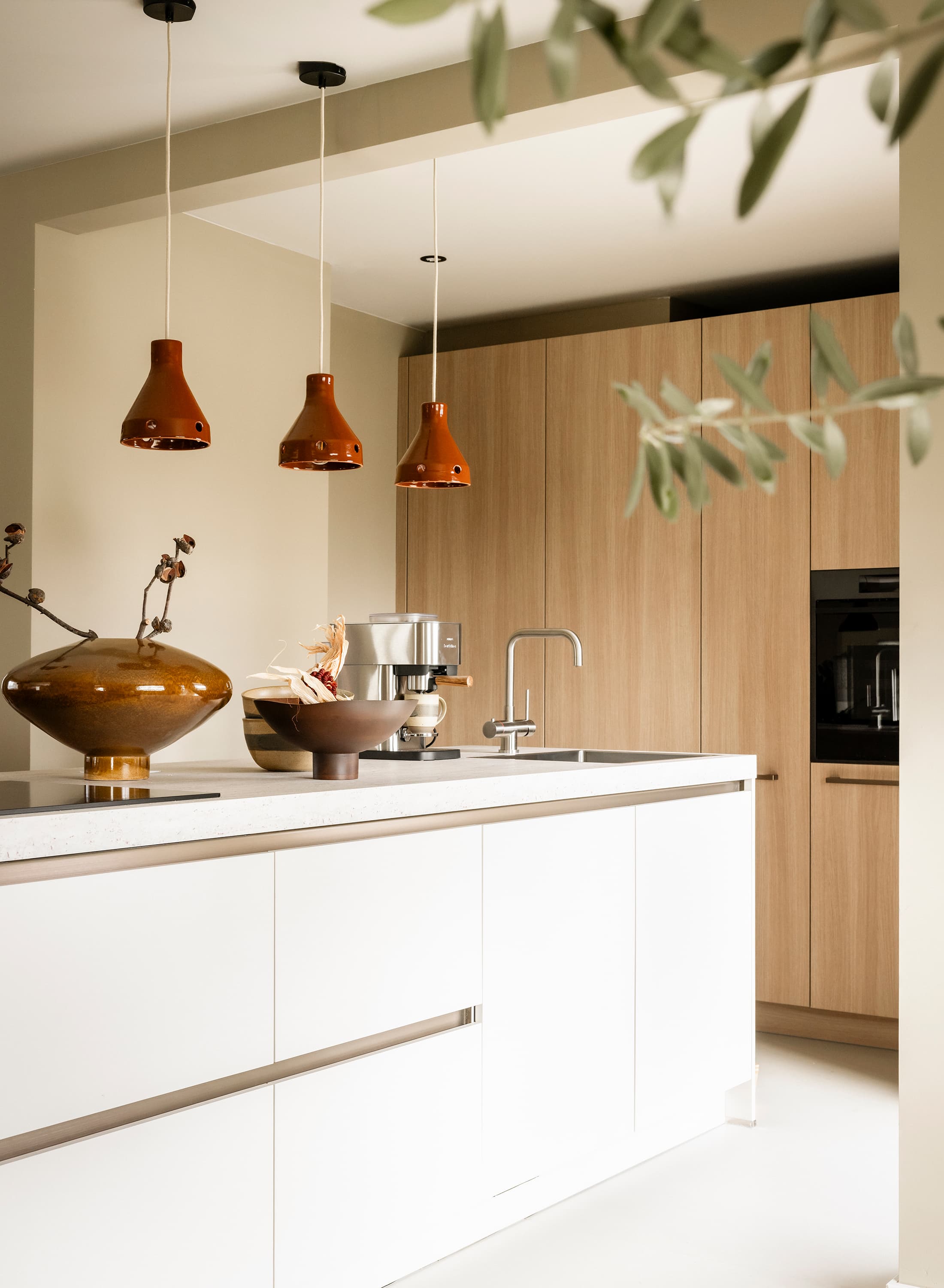 Kookeiland-met-witte-fronten-en-kastenwand-met-houten-fronten.jpg
